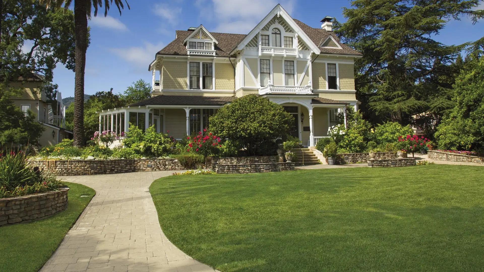 Victorian house with lush garden and walkway