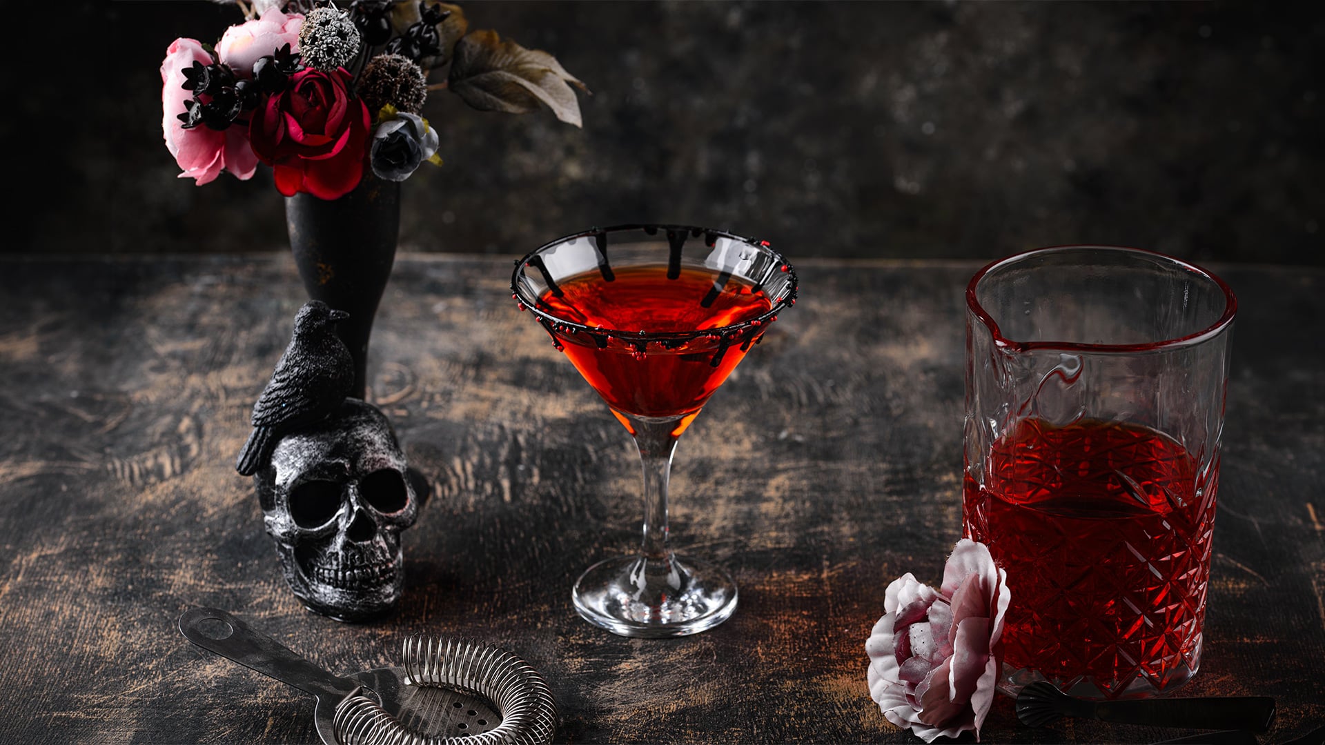 Gothic red cocktails beside skull, raven, and dark flowers