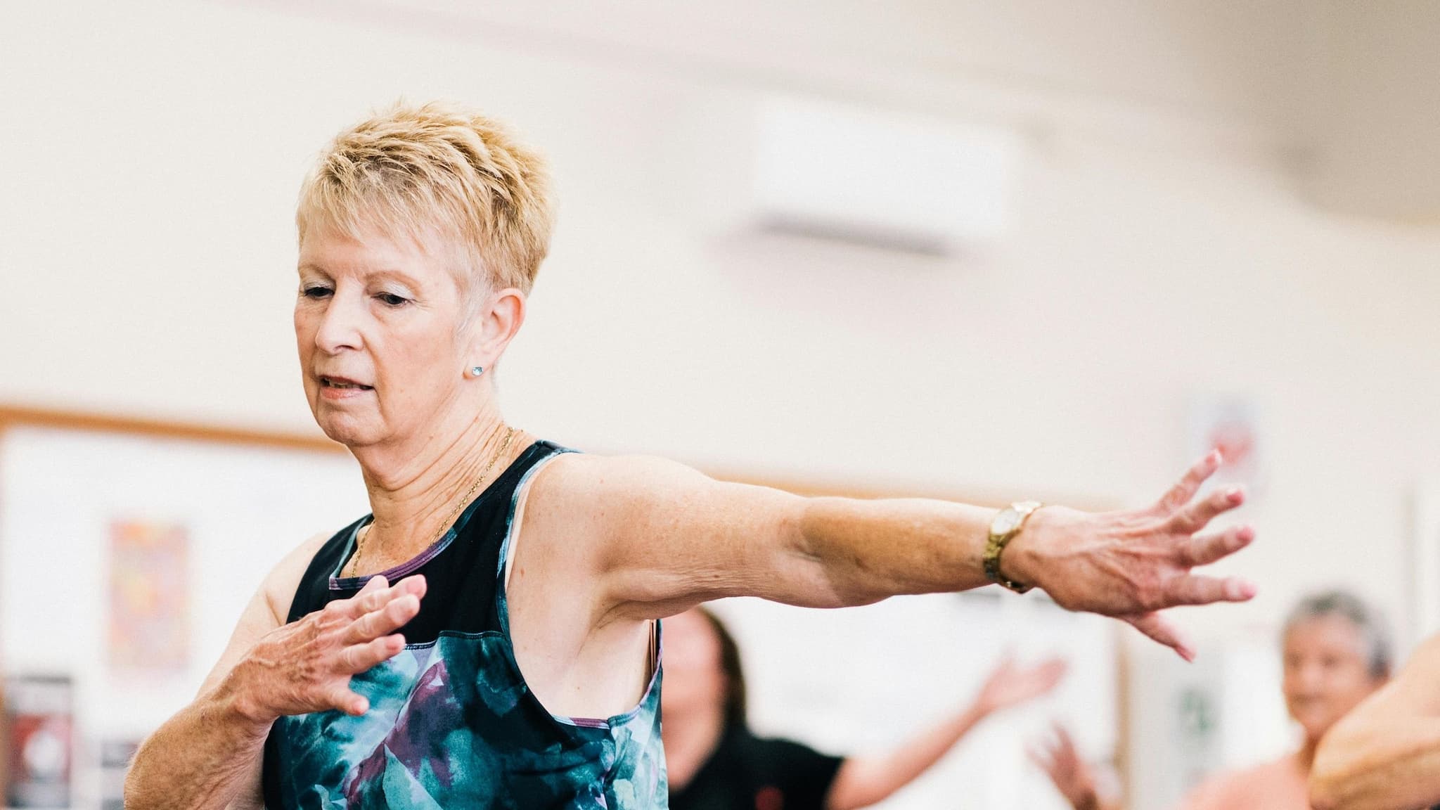 Older woman exercising in fitness class