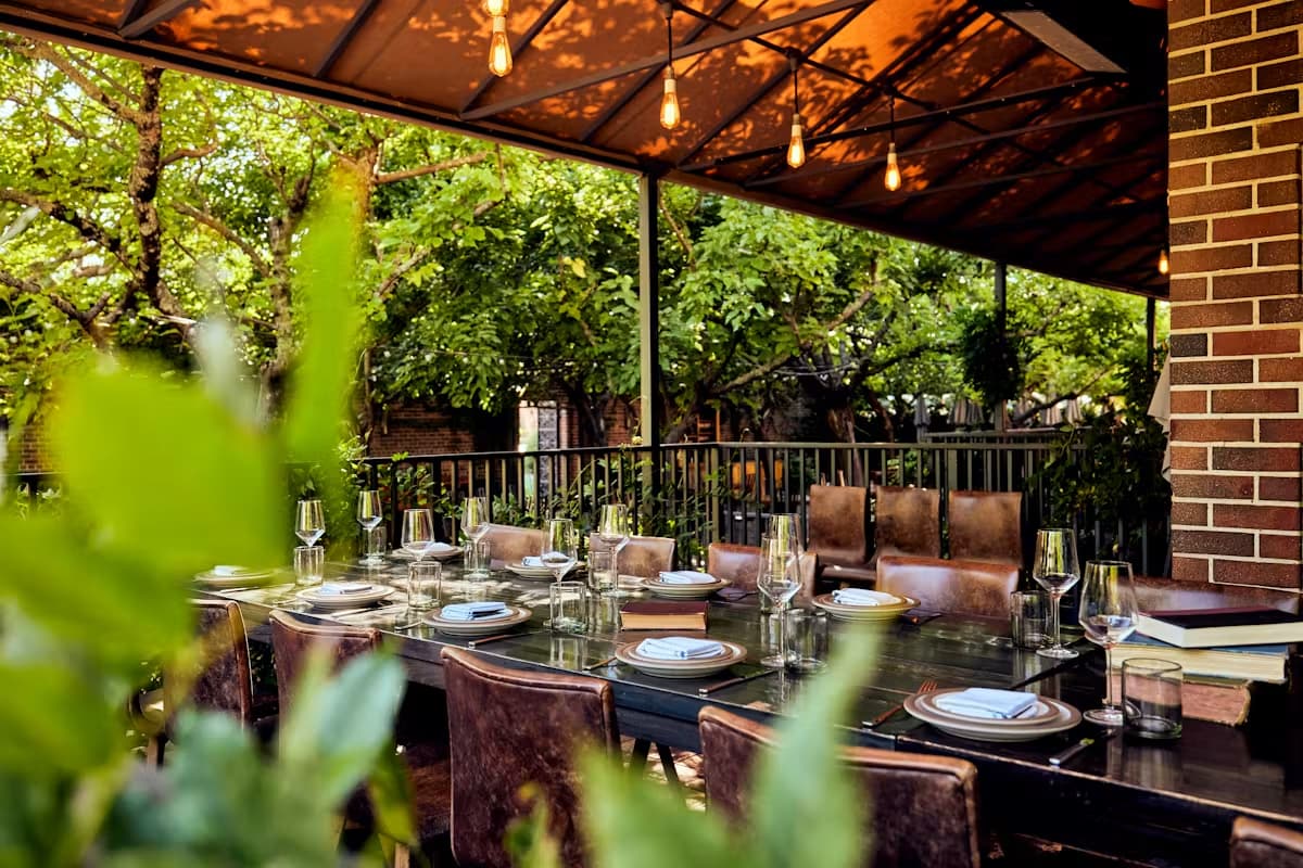 Outdoor patio dining table set under string lights