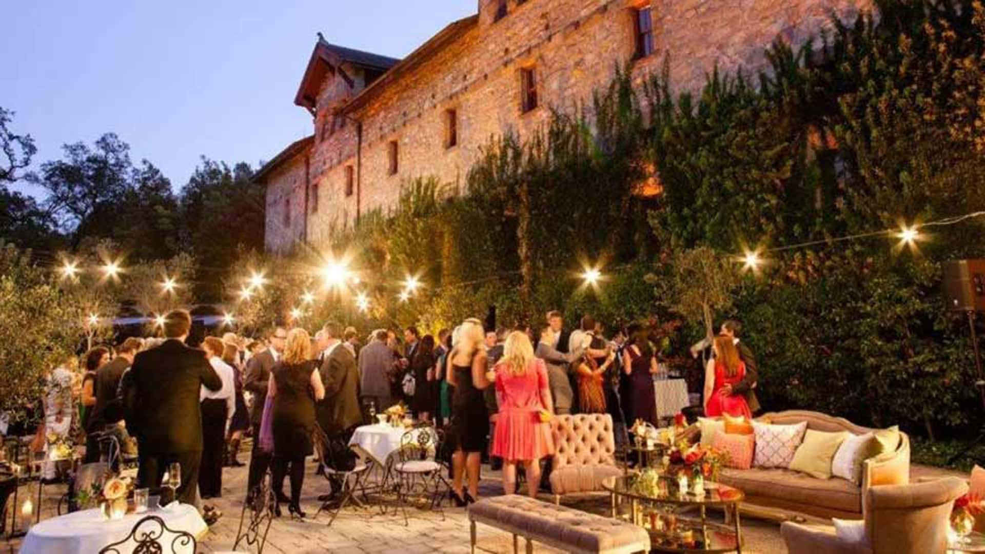 Outdoor evening party with lights and guests.