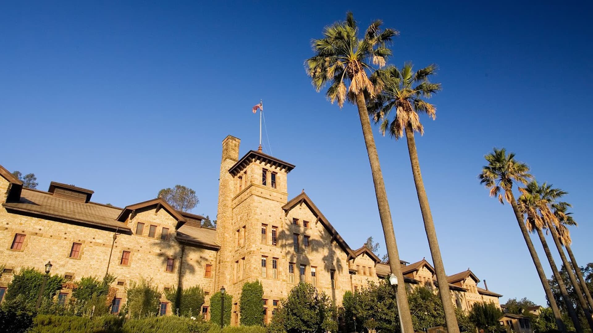 Historic stone building under clear blue sky.