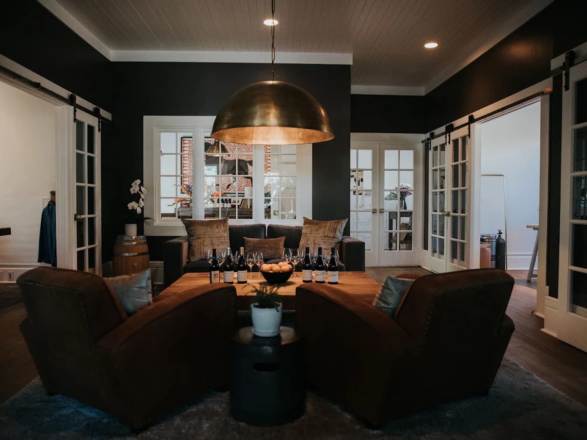 Cozy modern lounge with wine bottles and leather chairs