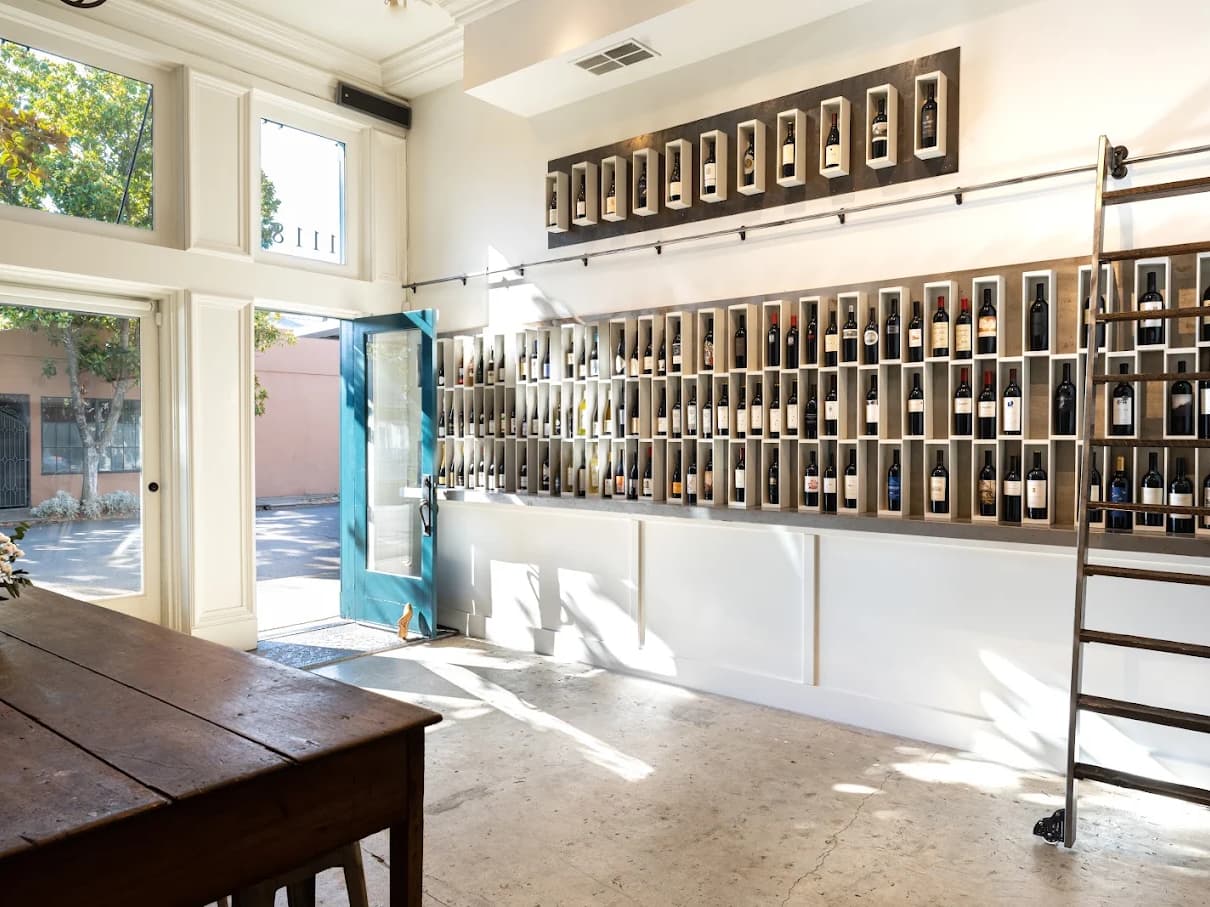 Bright wine shop with wall of bottles
