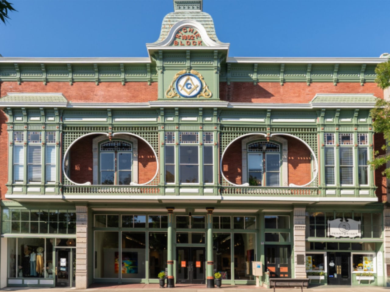 Historic brick building with ornate green facade