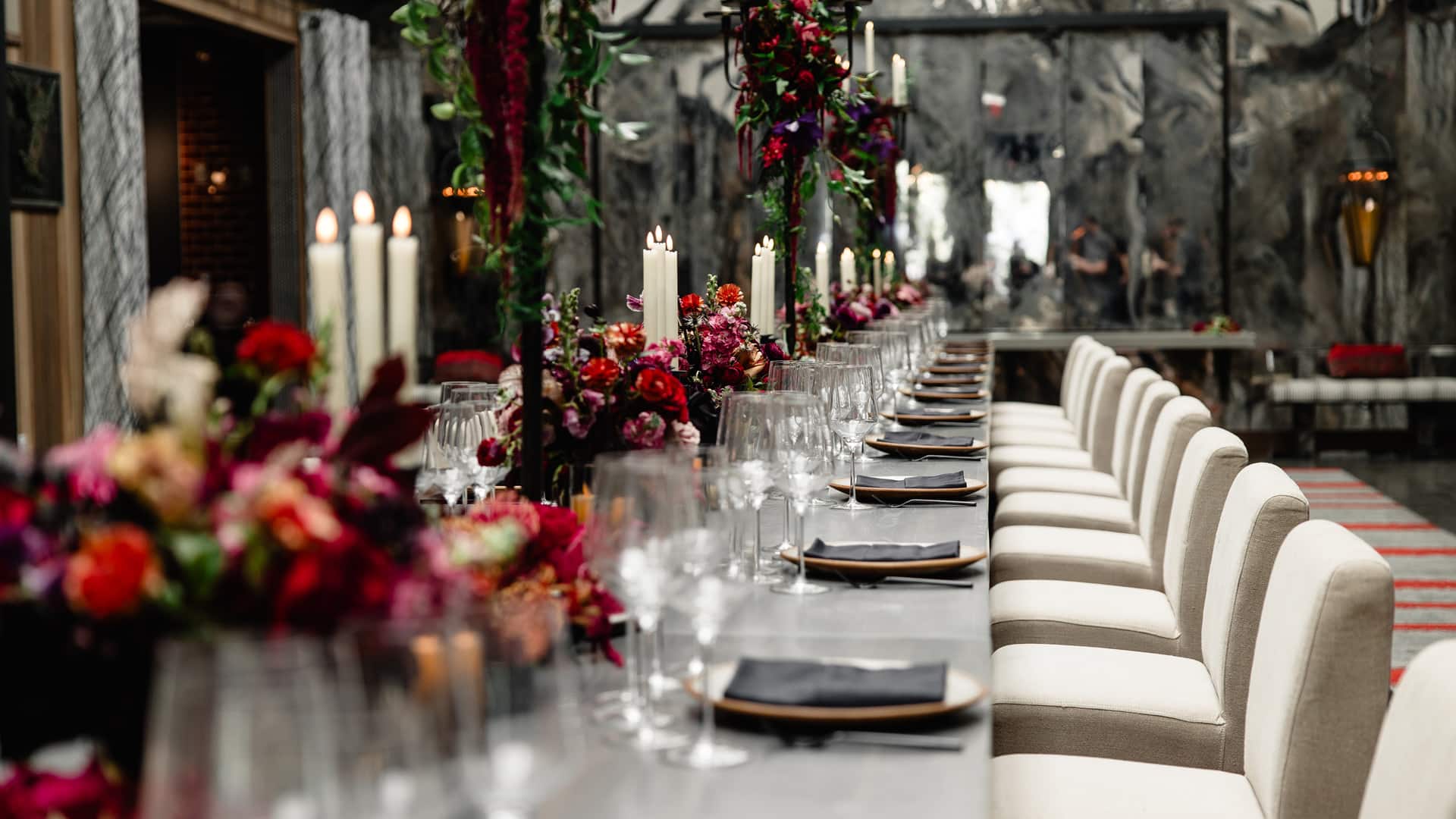Elegant dining table with floral arrangements and candles.