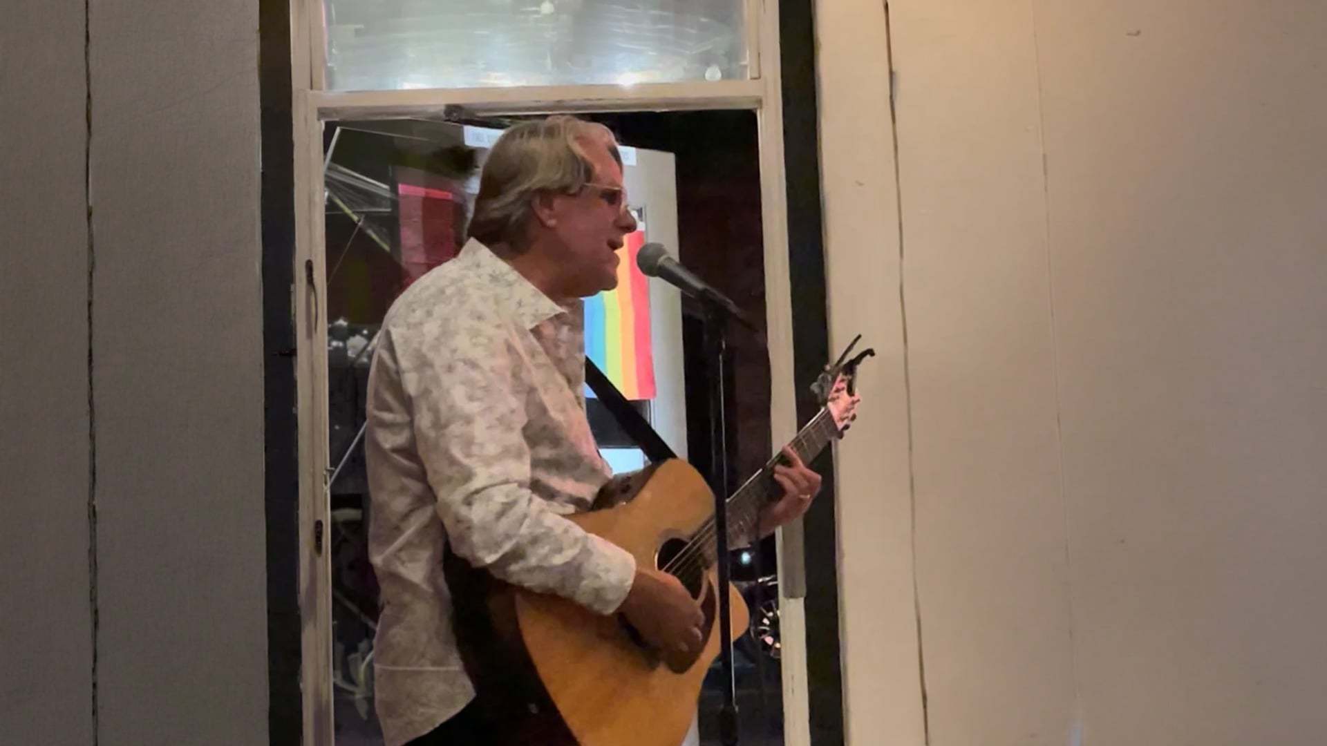 Man playing guitar and singing indoors