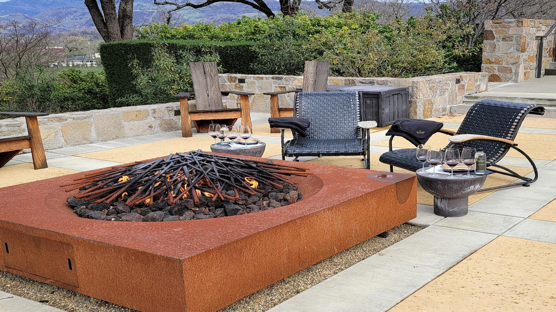 Cozy patio with chairs and a fire pit
