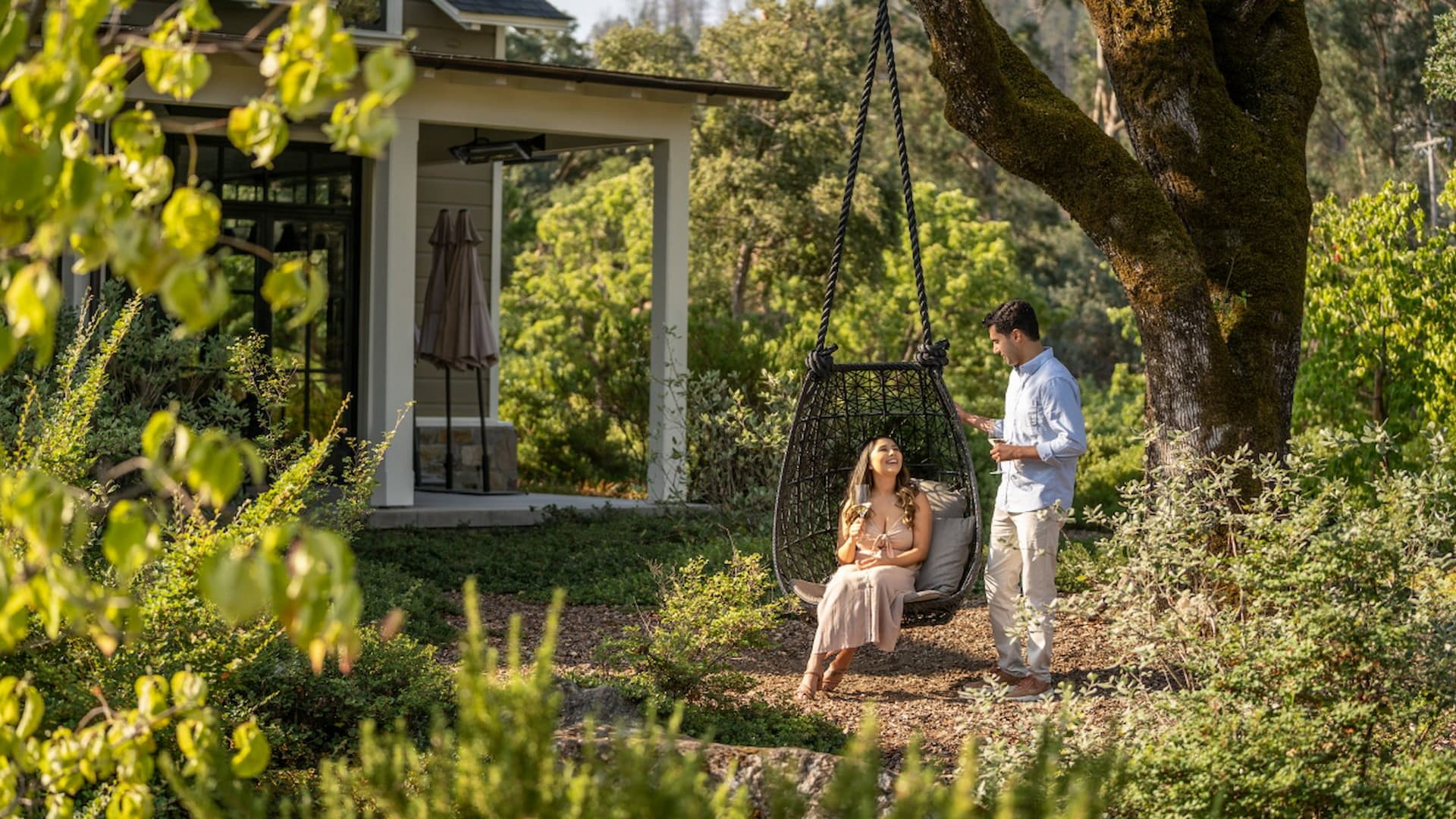 Couple enjoying conversation by garden swing seat