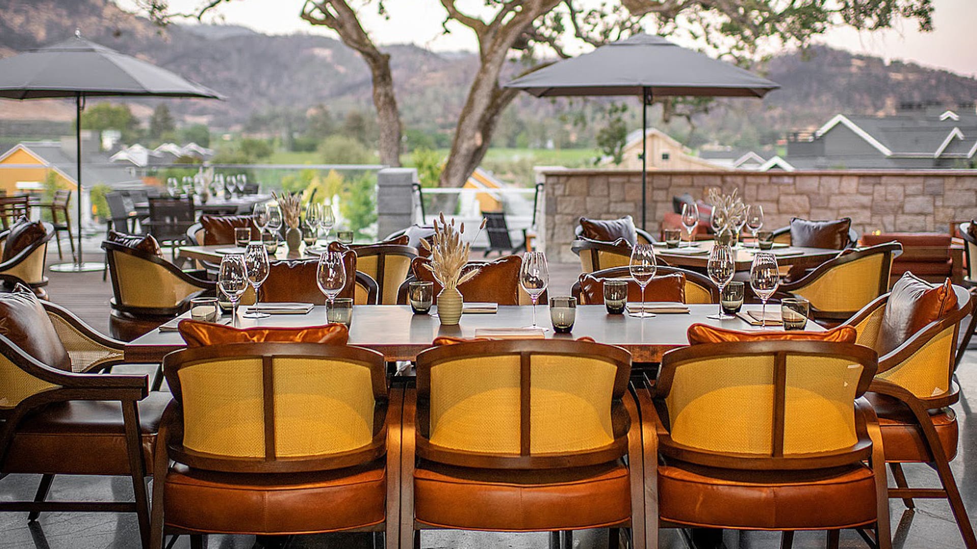 Outdoor patio dining with scenic view and tables.