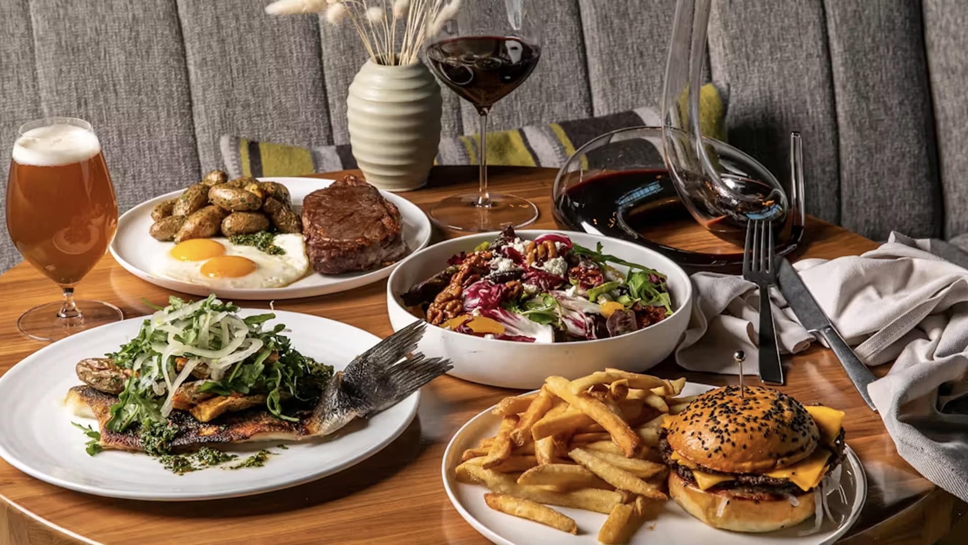 Gourmet meal with wine and beer served elegantly.