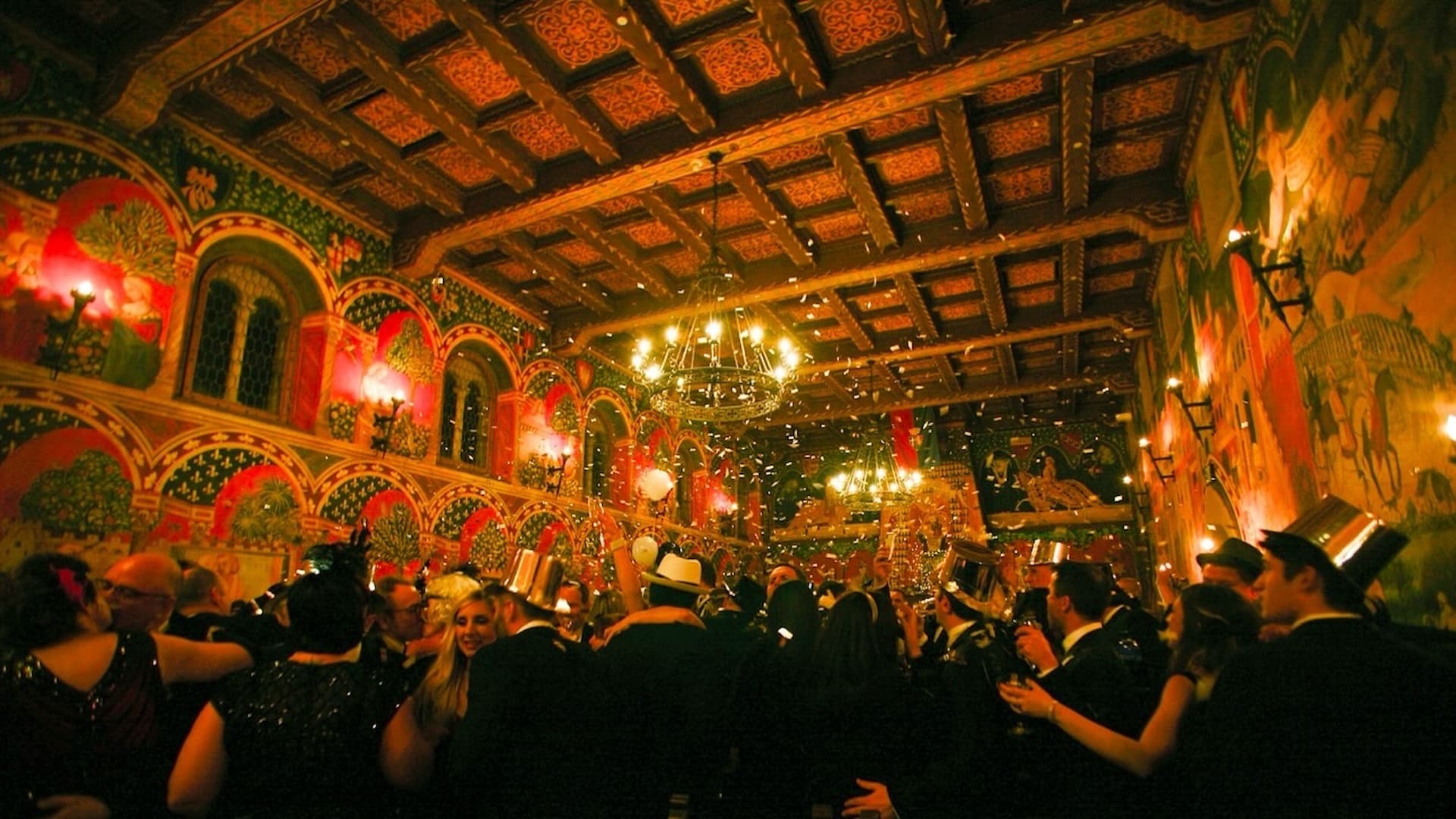 People celebrating in ornate festive hall.