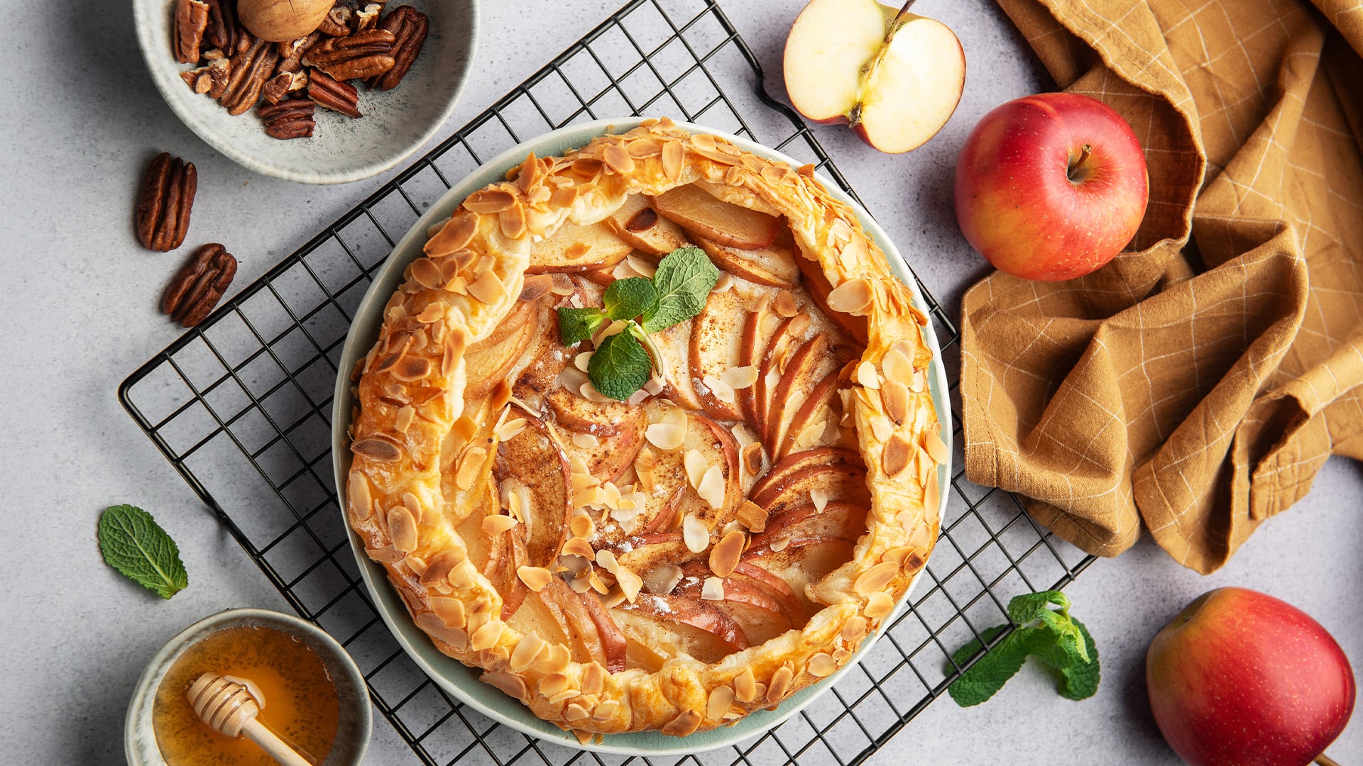 Delicious homemade apple galette with flaky crust topped with almonds and honey