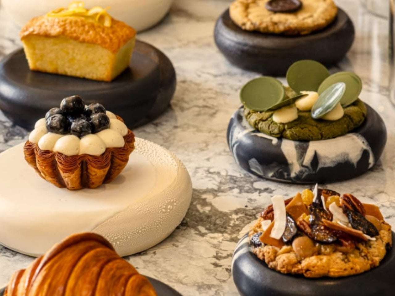 Assorted gourmet pastries on marble table display