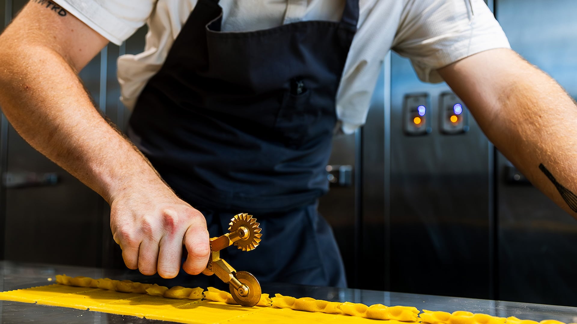 Chef cutting fresh pasta with pastry wheel