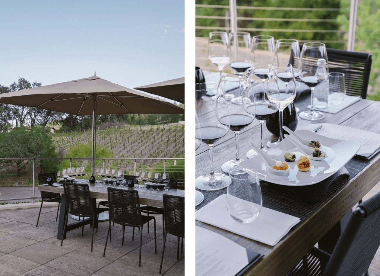 Outdoor dining with wine glasses and appetizers.
