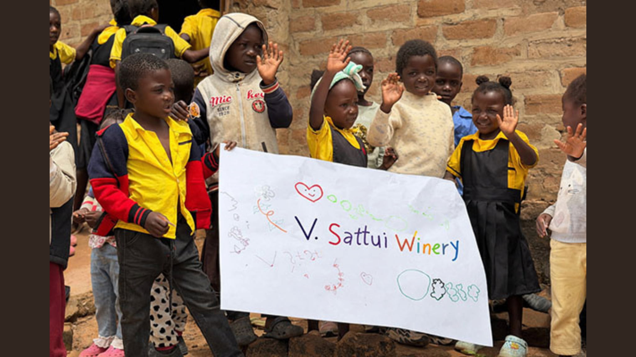 Children waving holding V. Sattui Winery sign