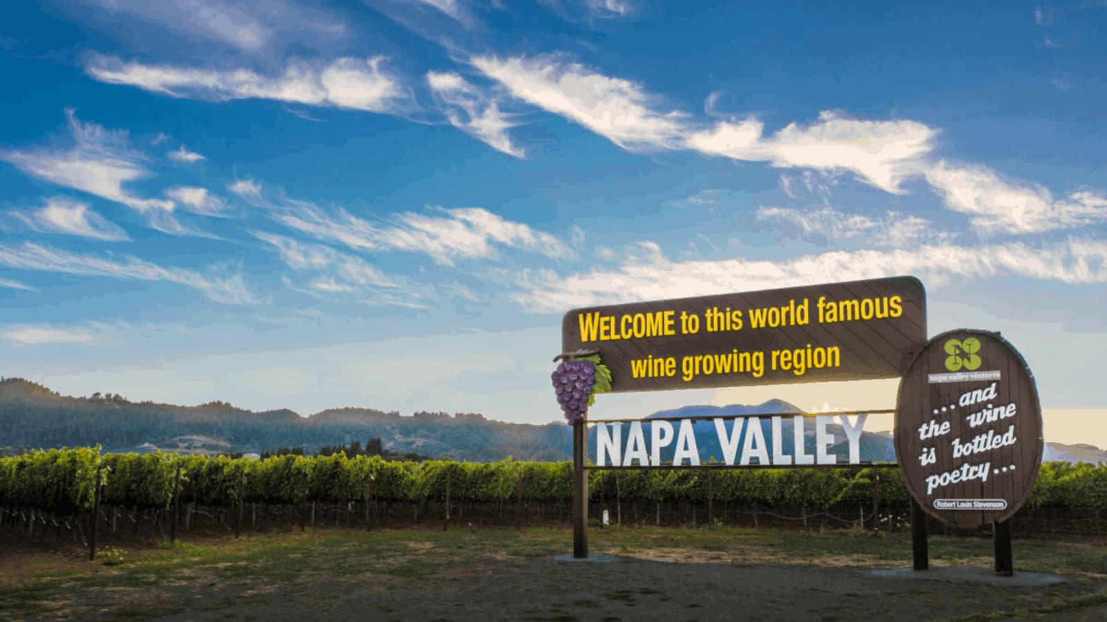 Napa Valley welcome sign in vineyard landscape.