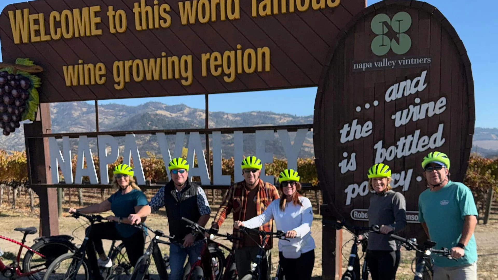 Cyclists visit Napa Valley wine region sign.