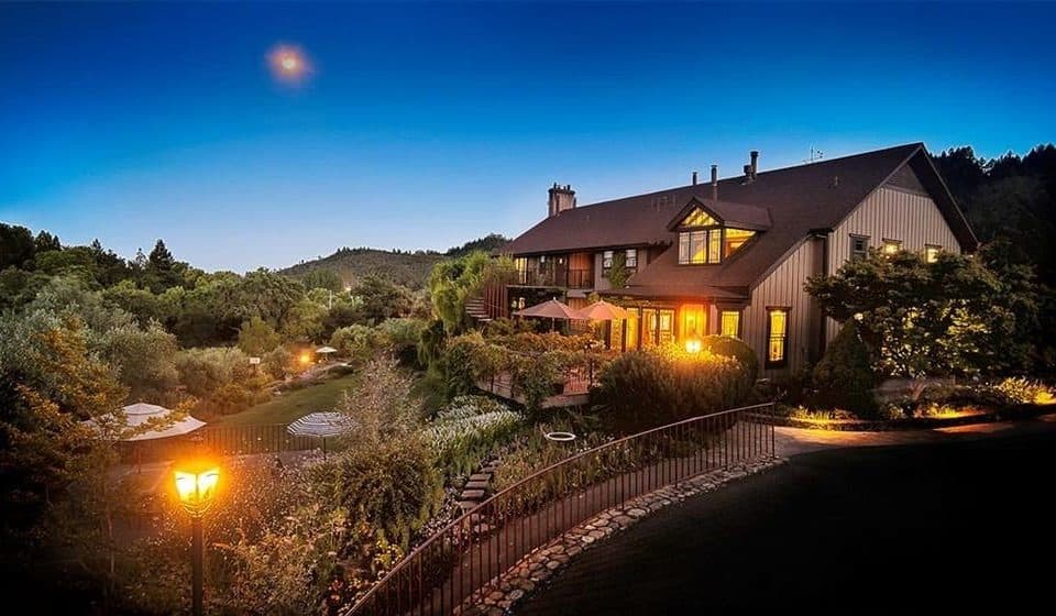 Illuminated house in picturesque evening landscape