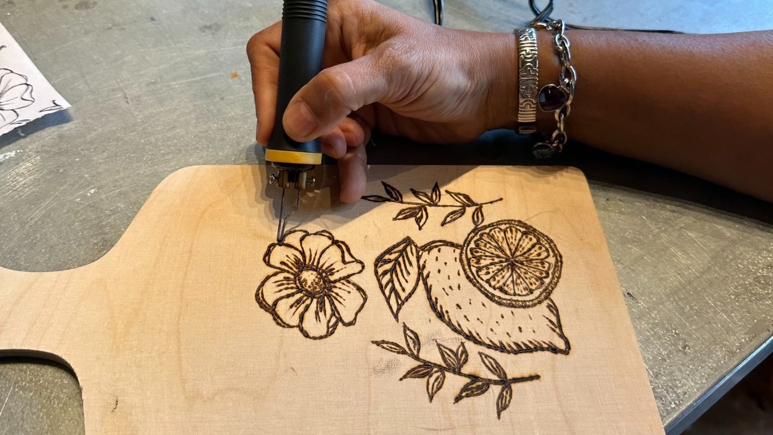 Hand wood-burning floral lemon design on cutting board