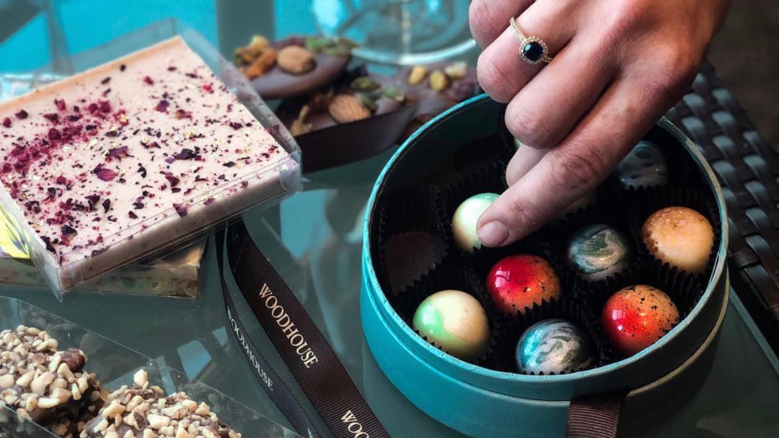 Hand picking chocolates from a box.