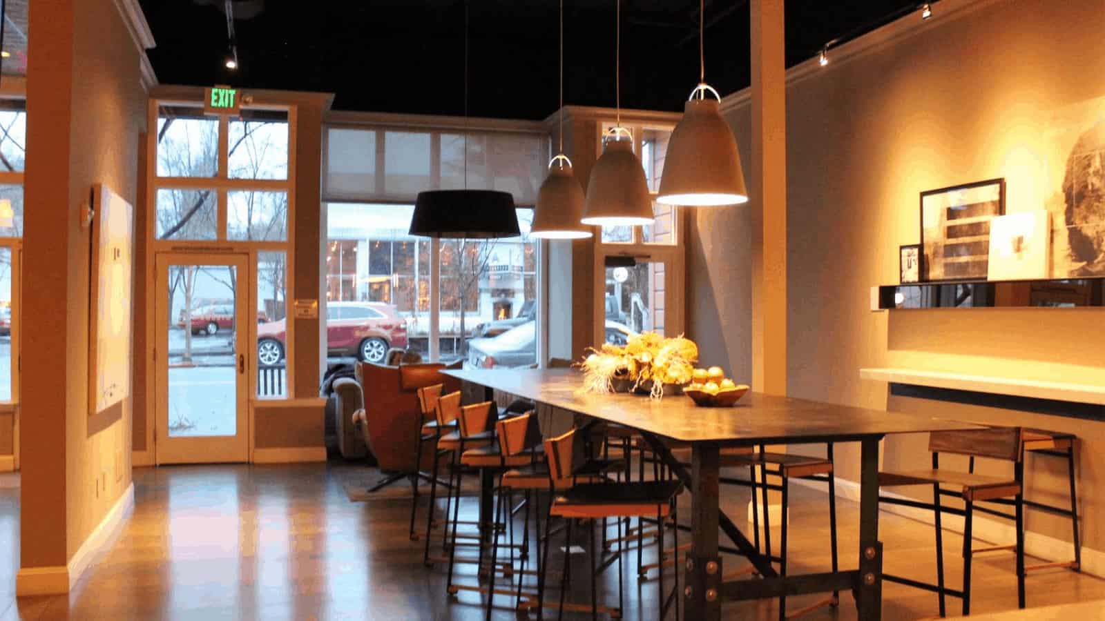 Modern cafe with pendant lighting and large windows.