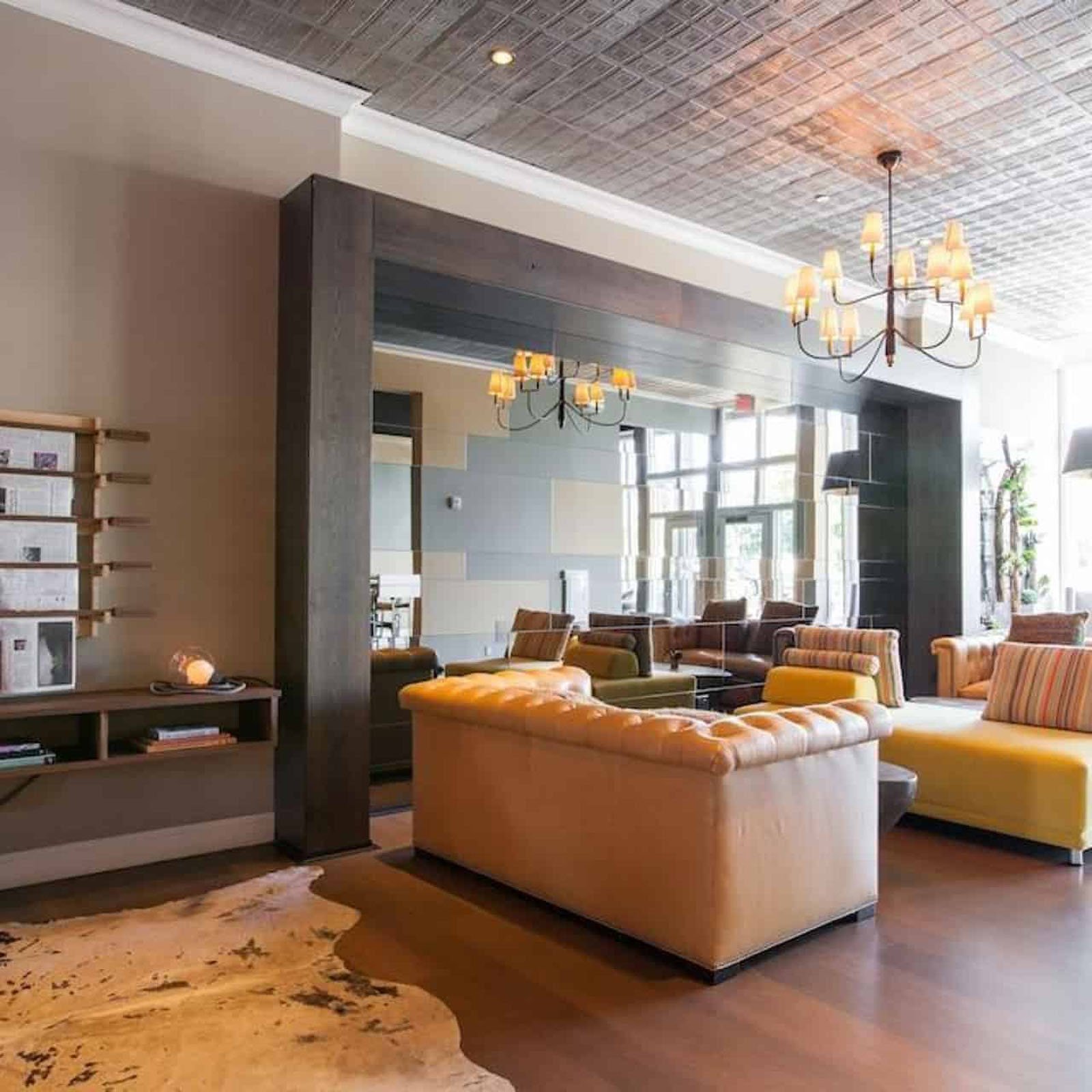 Cozy living room with modern decor and chandelier.