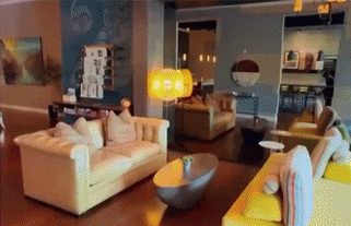Modern living room with cream sofas and warm lighting
